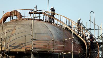 Workers are seen at the damaged site of Saudi Aramco oil facility in Abqaiq. Reuters