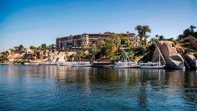 This picture taken on January 3, 2021 shows a Nile view of the Old Cataract Hotel overlooking the river in Egypt's southern city of Aswan, some 920 kilometres south of the capital, where British crime fiction writer Dame Agatha Christie is believed to have stayed while writing her 1937 novel "Death on the Nile". Over a century since it first cruised the glittering waters of the Nile, the steam ship "Sudan" draws tourists following the trail of legendary crime novelist Agatha Christie, whom it was inspired to pen one of her most famous whodunnits in 1937, "Death on the Nile". / AFP / Khaled DESOUKI