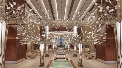The lobby area of the hotel welcomes guests with a forest of 14 bronze metal trees. Courtesy Mandarin Oriental