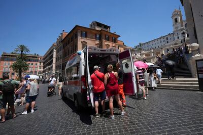 Paramedics help tourists in the heat by the Spanish Steps, in Rome, Italy. AP Photo