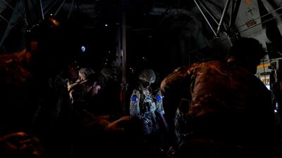 A paratrooper from Britain's 16th Air Assault Brigade waits for the green light to jump from a transport aircraft as part of an exercise with Jordanian soldiers. AP Photo