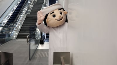 An Etihad Rail mascot greets travellers.