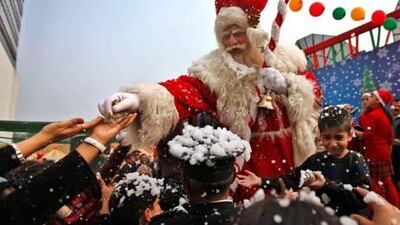 Santa Claus distributes sweets to children on the occasion of Christmas at Le Meridien hotel in New Delhi yesterday. Christians in India make up just over 2 percent of India's one-billion-strong population.