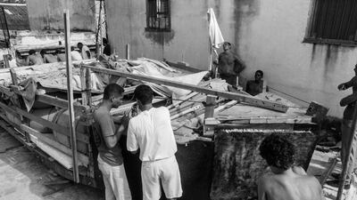 People put the finishing touches to a makeshift boat.