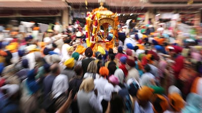 Sikh devotees carrying the Sri Guru Granth Sahib ji, the holy book of Sikh religion, during a procession in Amritsar, India. EPA