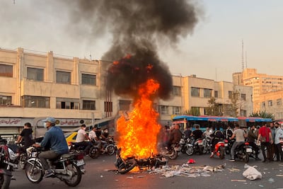 A burning motorcycle in Tehran during the unrest of 2022. AFP