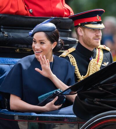 Meghan, Duchess of Sussex waves to crowds, showing off a new ring. Getty Images