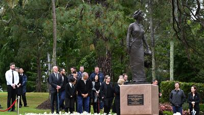 People gather around a statue of the queen at Government House in Brisbane, Australia. EPA