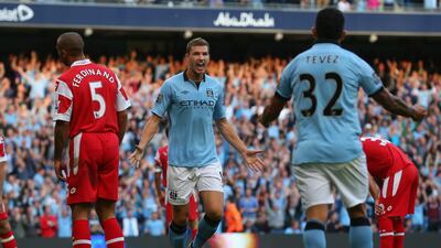 Edin Dzeko celebrates his goal with Carlos Tevez. Alex Livesey/Getty Images