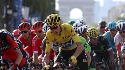 Chris Froome rides with the rest of the peloton with the Arc de Triomphe in the background on his way to being crowned winner of the Tour de France for a third time. Kenzo Tribouillard / AFP