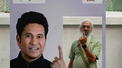 Senior citizen Amol Prabhu shows his marked finger after voting in Mumbai on Wednesday. AP