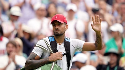 Nick Kyrgios wears a red cap as he enters Centre Court. PA