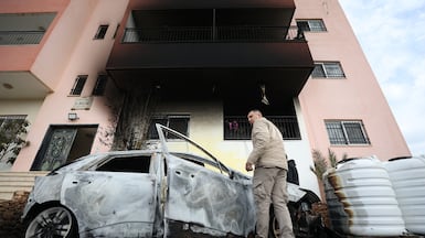 Palestinians inspect damage in the West Bank village of Deir Al Hatab after an Israeli settler attack. EPA