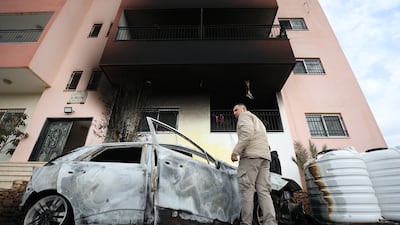 Palestinians inspect damage in the West Bank village of Deir Al Hatab after an Israeli settler attack. EPA