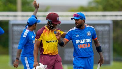 India captain Hardik Pandya, right, talks to West Indies' Shai Hope at the end of the fifth T20 cricket match at Central Broward Regional Park. AP