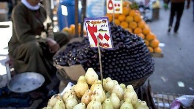 A street vendor displays price tags for fruits in Cairo. The Egyptian pound slipped further against the dollar during the past two weeks. Nasser Nasser / AP Photo