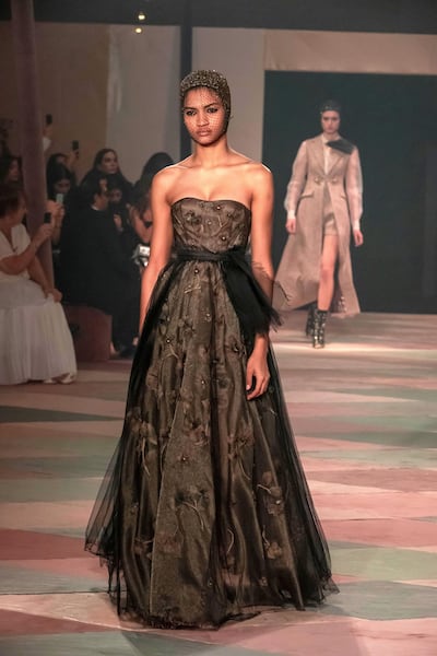 A dress with flowers encased in its layers, from Dior's spring 2019 haute couture collection, presented in Dubai. Antonie Robertson / The National