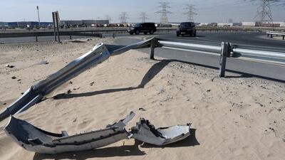 Debris from a recent car accident litters the side of the road at the U-turn going towards Jebel Ali industrial area in Dubai. Motorists are calling for traffic lights to be installed. Pawan Singh / The National