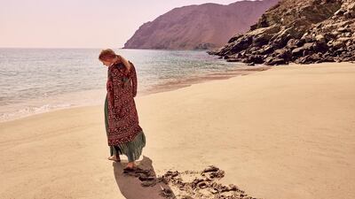 SUMPTUOUS STROLL: Dress, Dh2,645, Max & Co; Coat, Dh59,995, Burberry; Earrings, Dh380, Adelya at s*uce