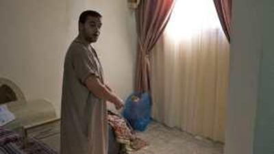 Fadi Abbed Rabbo stands in the bedroom he refurbished with materials he salvaged.