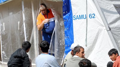 Illegal immigrants wait to take a shower and be examined by doctors on August 11, 2009 in Calais, a key exit point to Britain in northern France, after scabies plague is extending among the immigrant population. AFP