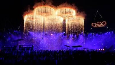 The Olympic rings, illuminated with pyrotechnics, are assembled during the Opening Ceremony at the 2012 Summer Olympics in London. AP Photo