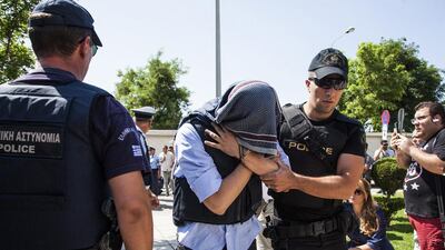 One of eight Turkish military officers who fled to Greece during the attempted coup last week is taken a court in Alexandroupolis on July 21, 2016. The men are now seeking asylum as the Turkish government cracks down on the coup plotters. Antonis Pasvantis / InTime News via AP