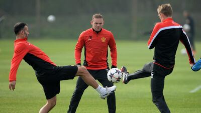 Manchester United players Wayne Rooney, centre, Ryan Giggs, left, and Darren Fletcher, right attend Monday's training session before they play Bayern Munich at Old Trafford on Tuesday night. Peter Powell / EPA / March 31, 2014