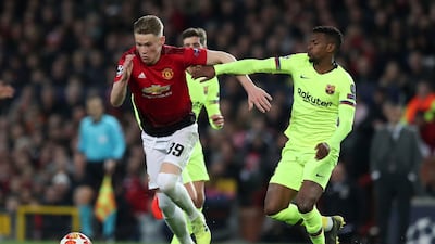 Manchester United midfielder Scott McTominay, left, takes on Barcelona defender Nelson Semedo. AP Photo