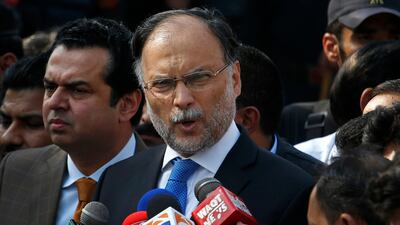 In this Oct. 2, 2017 file photo, Pakistani Interior Minister Ahsan Iqbal talks to journalists outside the accountability court, in Islamabad, Pakistan. Pakistani officials said Sunday, May 6, 2018, that a gunman opened fire on Iqbal after a public meeting, wounding him in shoulder. Anjum Naveed / AP