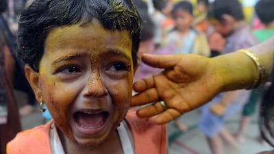 A child at nursery cries after being smeared with natural colours from vegetable paste during Holi celebrations at a city civic school in Mumbai. Indranil Mukherejee / AFP Photo