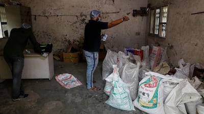 Naman Sharma, a volunteer of Shri Devouthan Sewa Samiti, a non-profit organisation, sprinkles holy water on bags containing unclaimed ashes of victims who died from the coronavirus disease, at a crematorium in New Delhi, India. Reuters