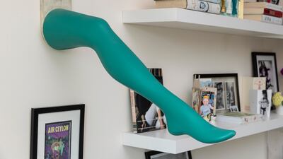 A green leg juts out of the wall in in the living room
