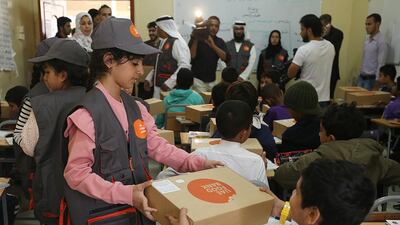 Volunteers distribute food boxes at Manar Al Eman Charity School as part of UAE Food Bank Initiative in Ajman. Satish Kumar / The National