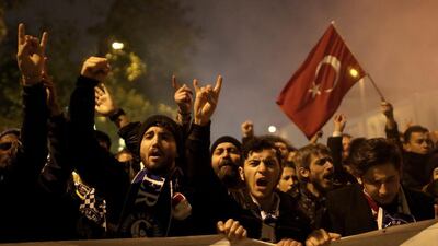 Turkish football fans shout slogans as they protest against twin bombings two days before, near the scene of one of the explosions outside the Besiktas Vodafone arena on December 10, 2016. Sedat Suna/EPA