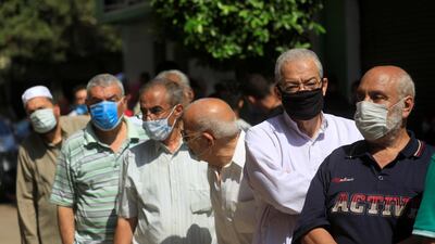 People wait in line to cast their votes. Reuters