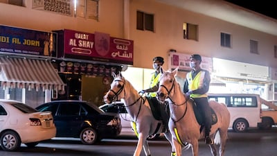 Police officers patrol residential and commercial areas on horseback in Dubai's Al Aweer neighbourhood to ensure residents stay indoors during the Covid-19 lockdown, April 16, Dubai, UAE. Reem Mohammed / The National