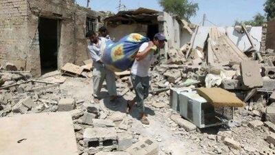 Residents collect their belongings amidst the rubble of destroyed houses following a series of bomb attacks in the town of Taji, north of Baghdad.