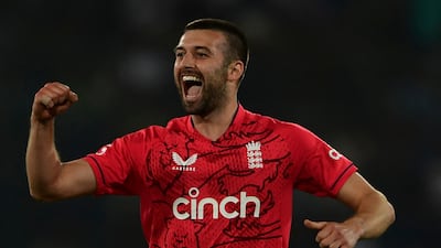 Mark Wood celebrates after taking the wicket of Pakistan's captain Babar Azam. AFP