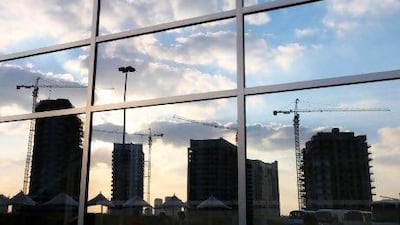 Buildings take shape around the cricket stadium at Dubai Sports City. Pawan Singh / The National