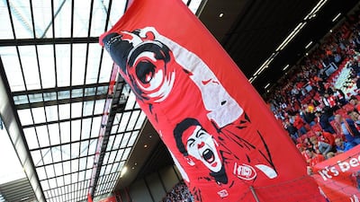 A flag with a drawing of Steven Gerrard is held up in the Kop stand at Anfield. Peter Powell / EPA