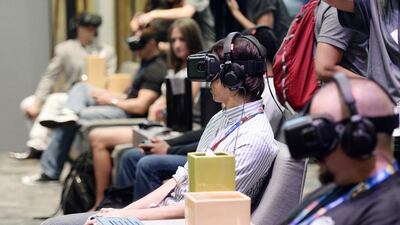 Attendees use Oculus Rift virtual reality headsets. Reuters