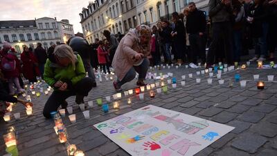 Brussels residents hold a candlelight vigil on November 18 for victims of the Paris attacks, in the suburb of Molenbeek where some of the attackers and suspect Salah Abdeslam lived. Emmanuel Dunand / AFP.