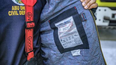 A crew member shows his FR3 Fire Shark Structural Firefighter Suit