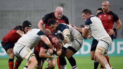 England flanker Tom Curry, centre, is tackled by US lock Ben Landry, second right, during the Pool C match. AFP
