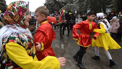 Children dance during celebrations in a village near Bishkek, Kyrgyzstan. An annual income of $8,997 is sufficient to be happy in this country. Photo: AFP