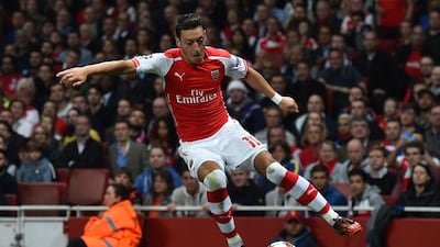 Arsenal midfielder Mesut Ozil controls the ball during the Uefa Champions League qualifying round play-off second-leg match against Besiktas at the Emirates Stadium in London on August 27, 2014. Ben Stansall / AFP