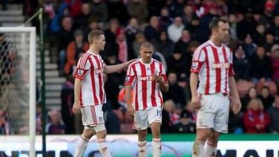 Stoke's Jonathan Walters, centre, is consoled by his captain Ryan Shawcross after scoring an own goal during his team's 4-0 loss to Chelsea on Saturday.