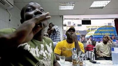 Football fans watch the match between Cameroon and Japan at the Sahar African Restaurant in Deira yesterday.