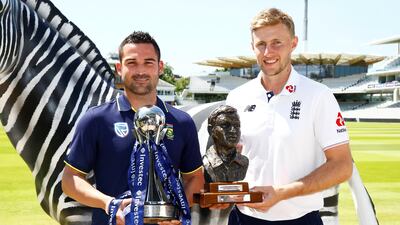 South Africa's Dean Elgar, left, and England's Joe Root pose with trophies aehad of the Test series between the two sides. Peter Cziborra / Reuters